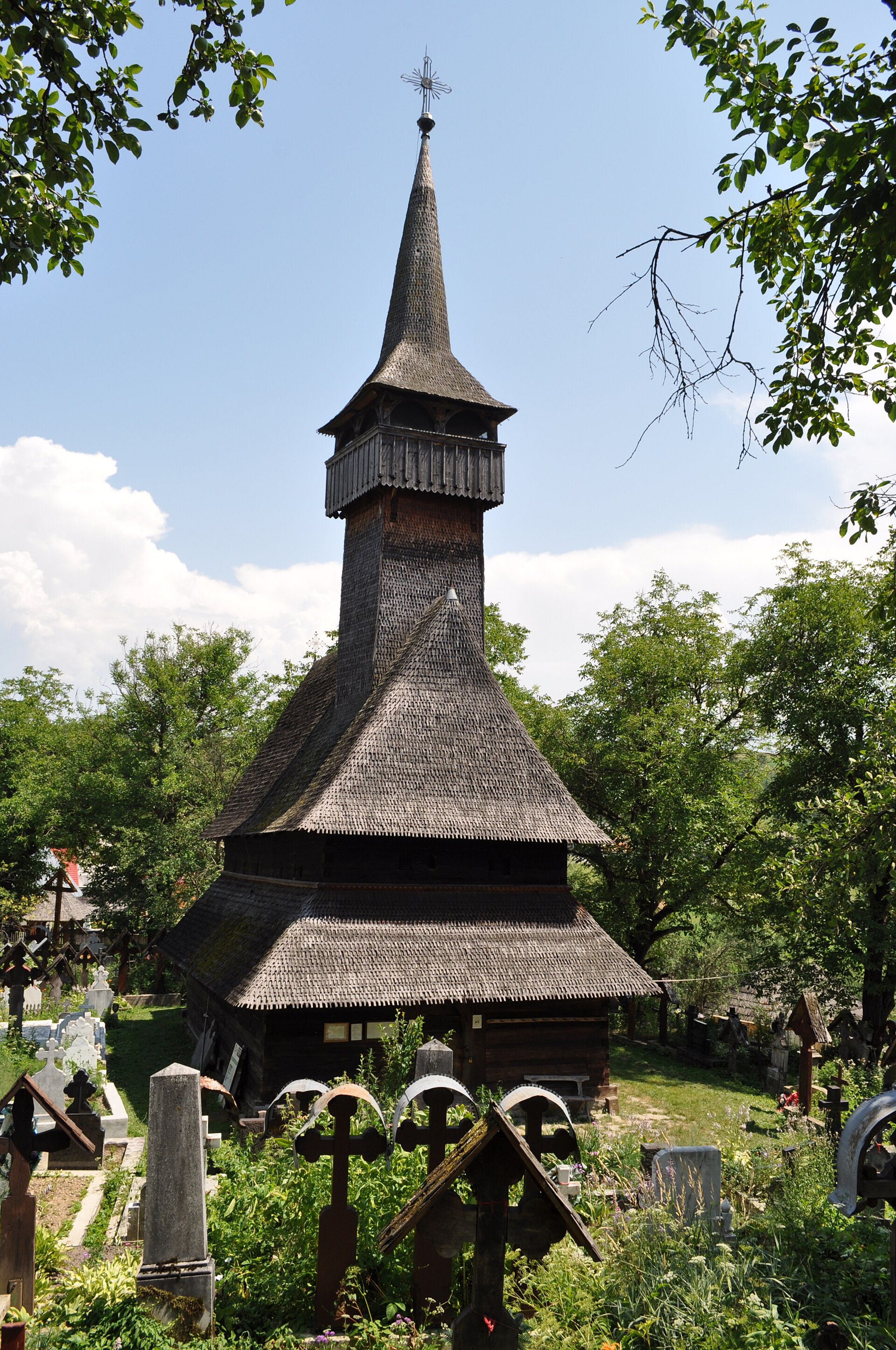 Wooden church with tall spire in Maramureș